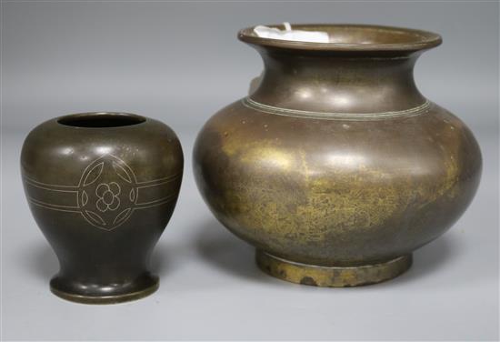 A bronze vase and a smaller bronze vase